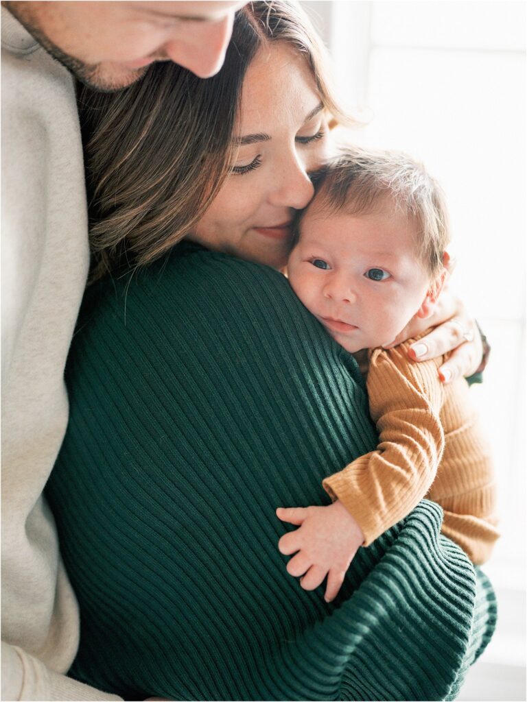 Mom snuggling her baby at a Home Newborn Session in Ankeny, Iowa