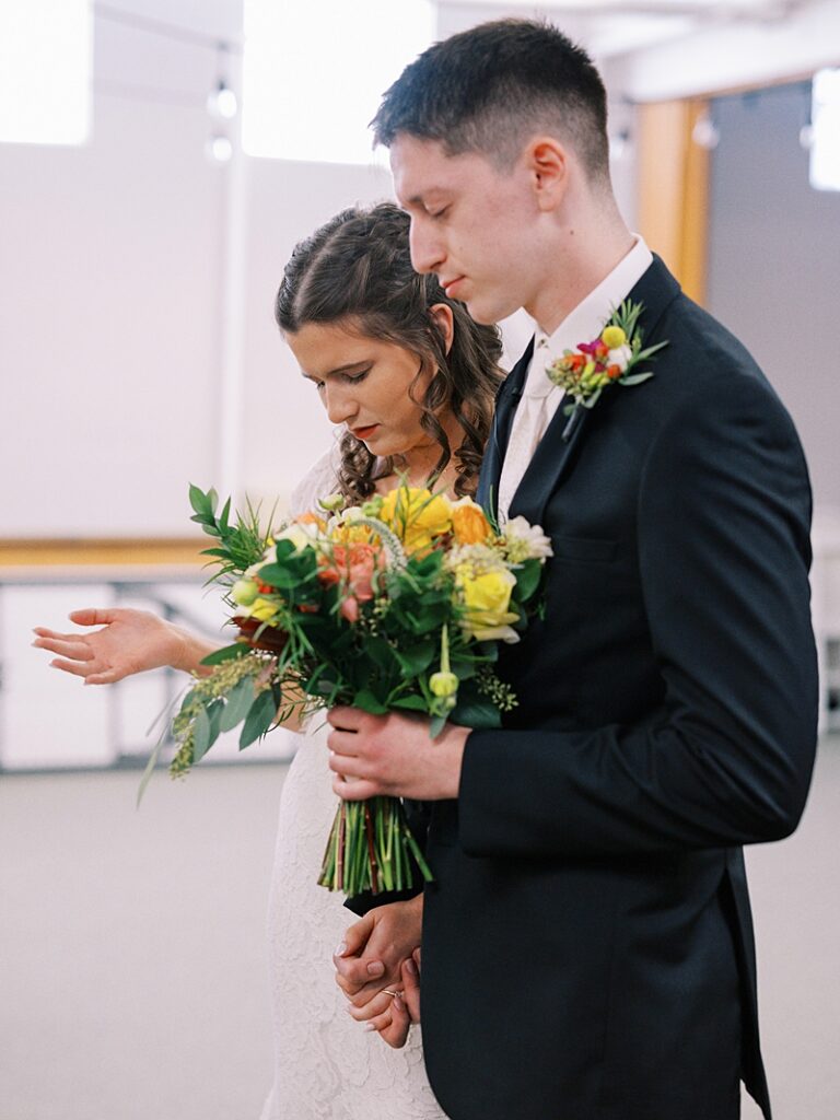 Bride and Groom praying at Country Cathedral Wedding