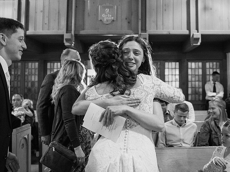 Bride and Groom hugging friends at Country Cathedral Wedding