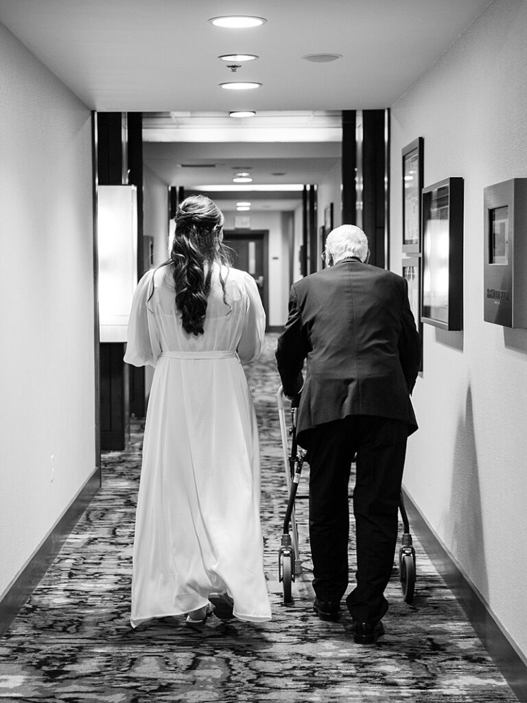 Bride and grandpa walking down hallway