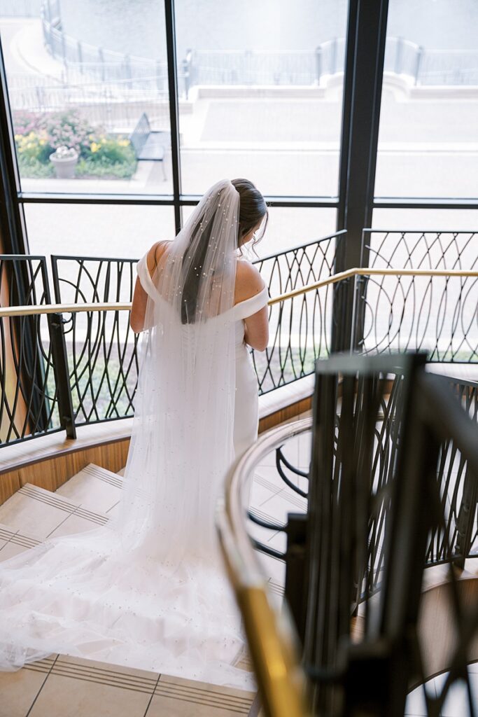 Bride walking down steps at Hyatt Regency Coralville